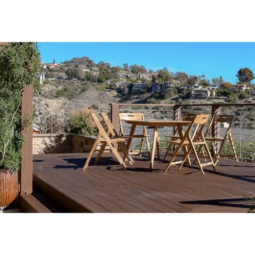 15917 Surf Teak Dining Table side view on deck overlooking houses on a mountain top