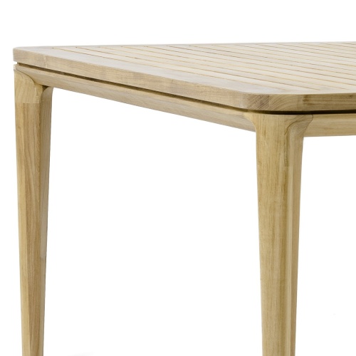 70879 Veranda teak 6 foot square dining table side angled closeup of legs and table top edge on white background