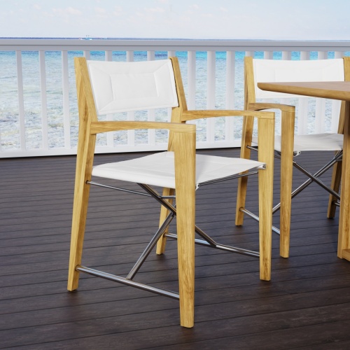 12915F Odyssey Chair side angled on wood patio with the ocean in the background