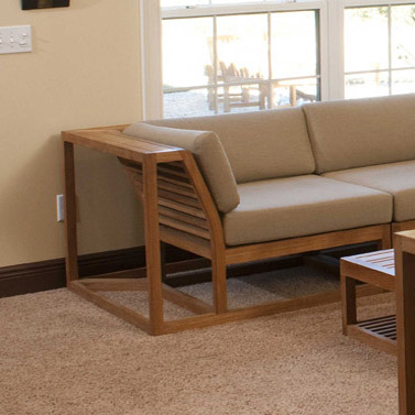 12800dp maya teak corner sectional collection front angle view indoors on carpet back against windows with outdoor landscaped background