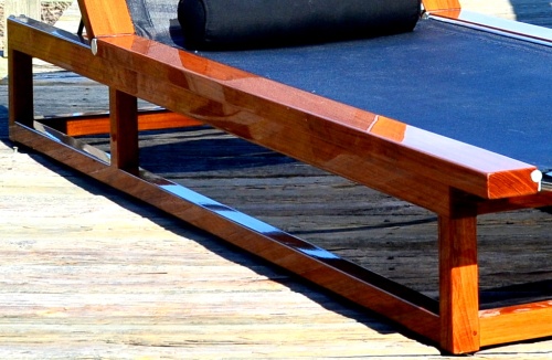 70939 Maya Teak Sling Lounger in black textilene mesh a close up view of marine grade finish on paver pool deck